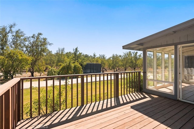 wooden terrace with a yard