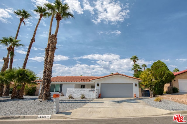 mediterranean / spanish home featuring a garage