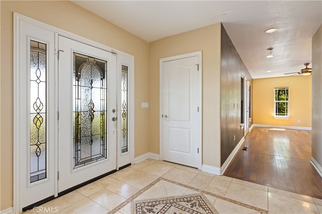 entrance foyer featuring a textured ceiling, light hardwood / wood-style floors, and ceiling fan