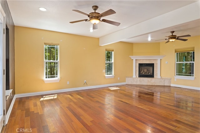 unfurnished living room with a fireplace, hardwood / wood-style floors, and plenty of natural light