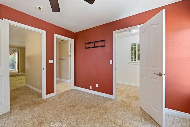 unfurnished bedroom featuring ceiling fan and light colored carpet