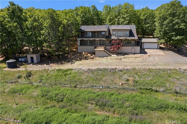 view of front facade featuring a garage and an outbuilding