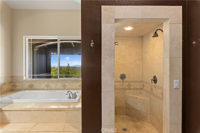 bathroom featuring shower with separate bathtub