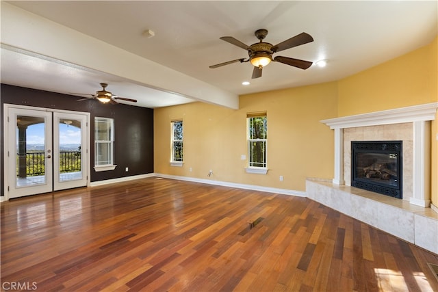 unfurnished living room with wood-type flooring and ceiling fan