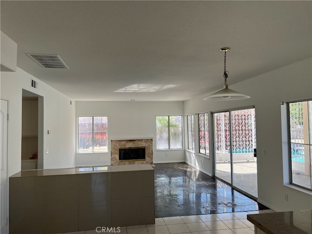 unfurnished living room featuring a textured ceiling and a fireplace