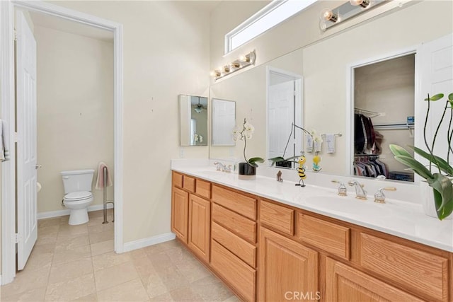 bathroom featuring tile patterned floors, vanity, and toilet