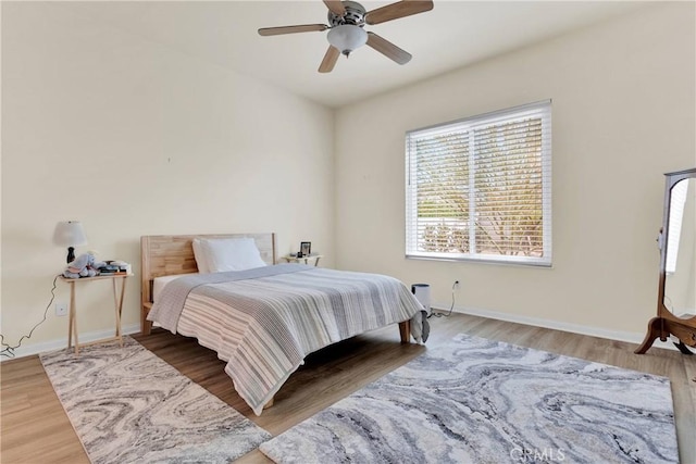 bedroom with wood-type flooring and ceiling fan