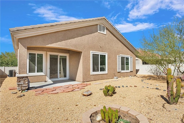 rear view of house with a patio and central AC unit