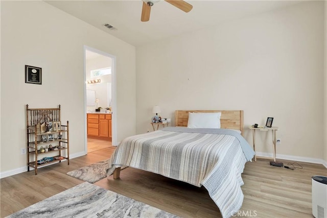 bedroom with ceiling fan, light hardwood / wood-style flooring, and ensuite bathroom