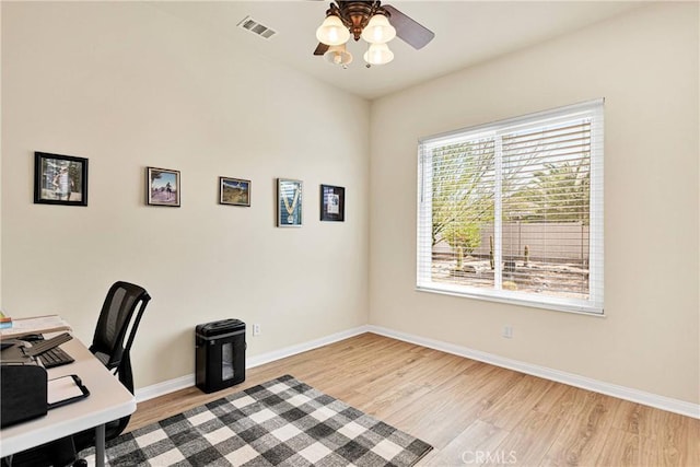 office area featuring plenty of natural light, ceiling fan, and light wood-type flooring