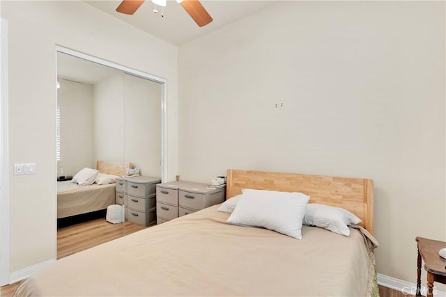 bedroom featuring ceiling fan, wood-type flooring, and a closet