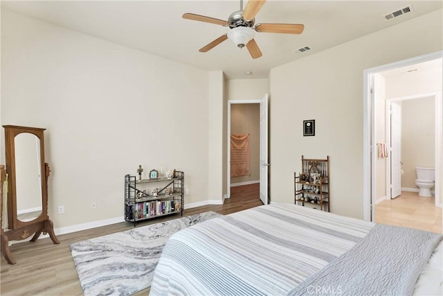 bedroom with ceiling fan, light hardwood / wood-style flooring, and ensuite bath