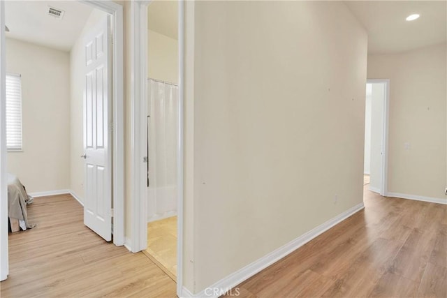 corridor with light wood-type flooring