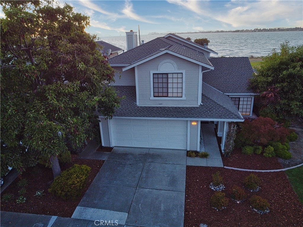 view of property featuring a water view and a garage