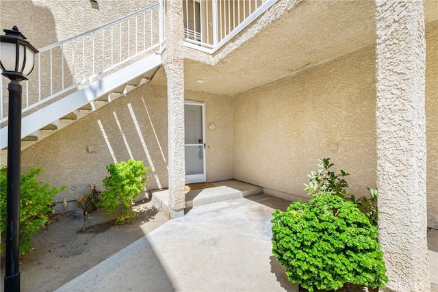 property entrance featuring a patio and a balcony