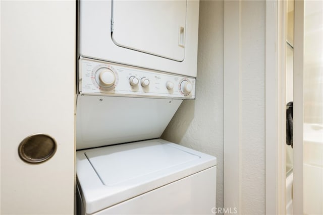 laundry area featuring stacked washing maching and dryer