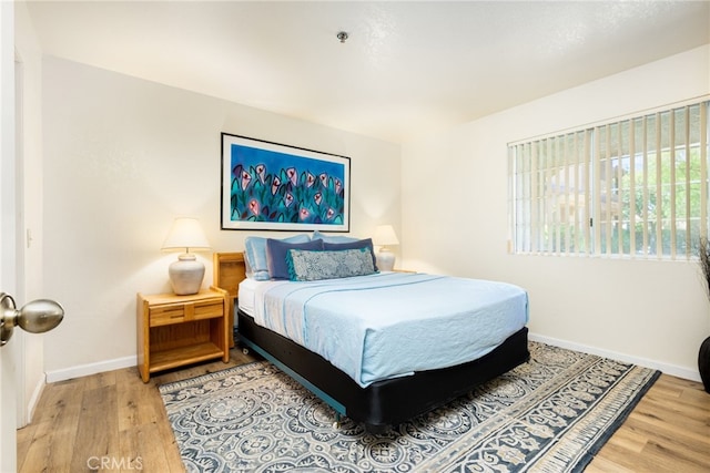 bedroom with hardwood / wood-style flooring