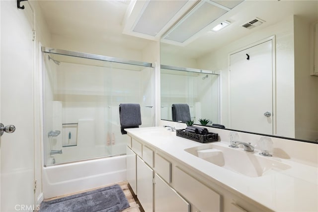 bathroom featuring vanity and enclosed tub / shower combo