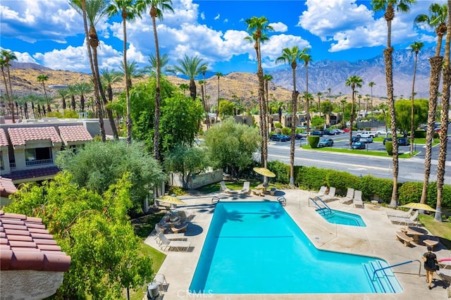 view of pool featuring a mountain view and a patio area