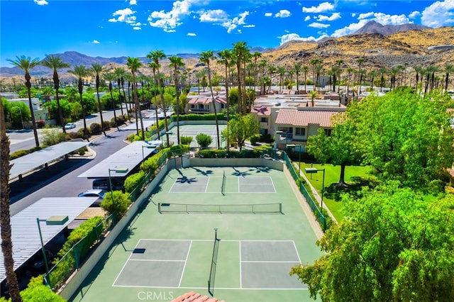 view of tennis court featuring a mountain view