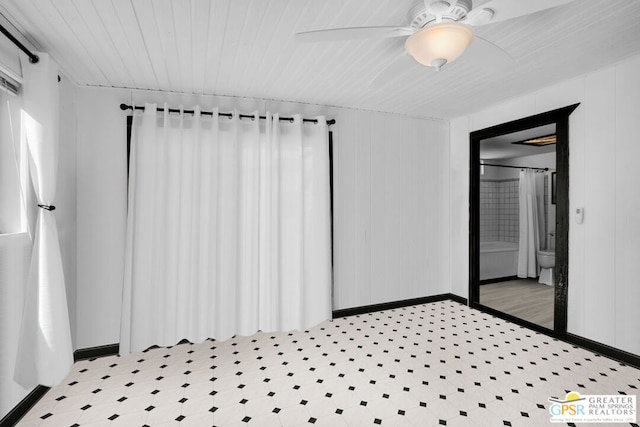 interior space featuring ceiling fan, radiator heating unit, and connected bathroom