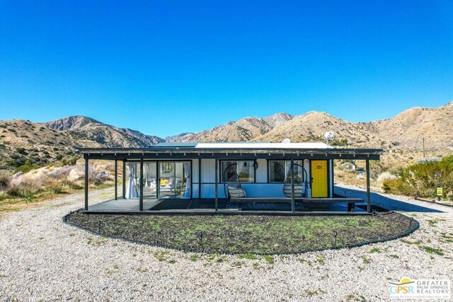 view of front of home featuring a patio area and a mountain view