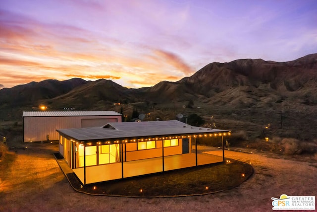 back house at dusk with a mountain view