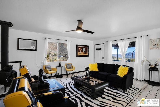 living room featuring ceiling fan and a wall mounted AC