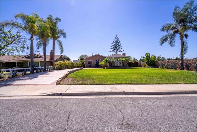 ranch-style home featuring a front yard