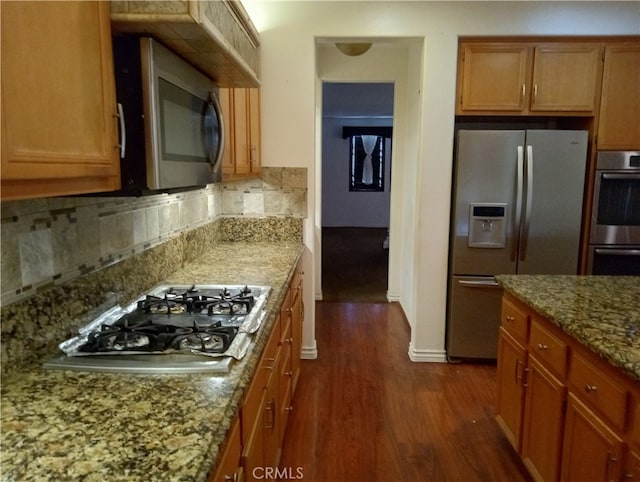 kitchen with light stone countertops, stainless steel appliances, dark hardwood / wood-style flooring, and tasteful backsplash