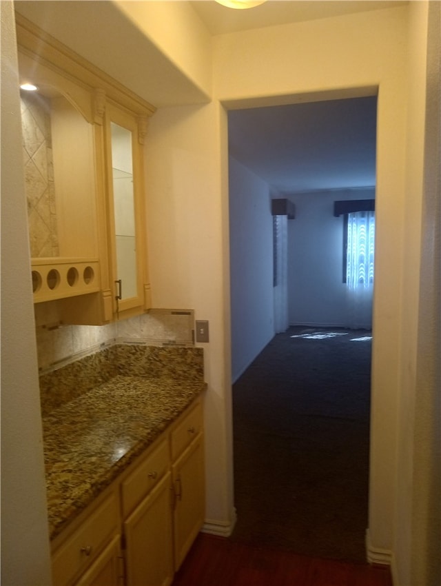 interior space featuring dark stone countertops and light brown cabinets