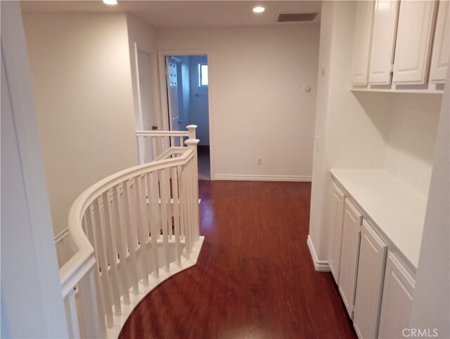 hall with dark wood-type flooring