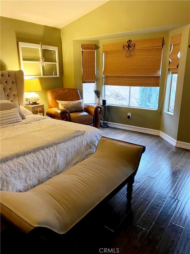 bedroom with hardwood / wood-style flooring, lofted ceiling, and multiple windows