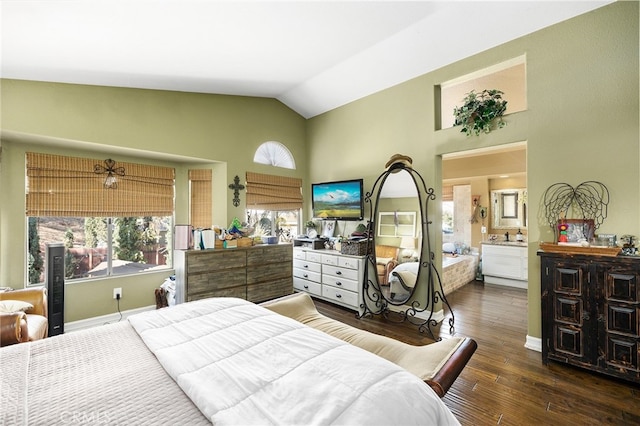 bedroom with ensuite bath, dark hardwood / wood-style flooring, and lofted ceiling