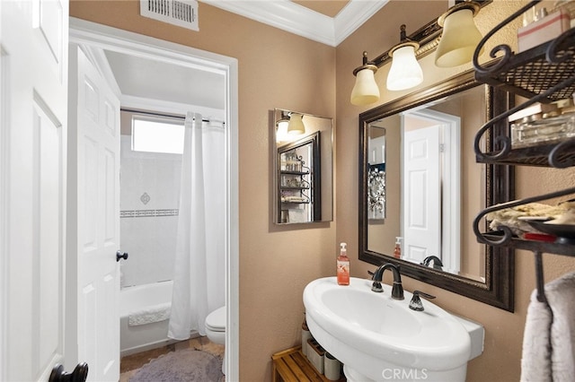 full bathroom with toilet, sink, shower / bathtub combination with curtain, and ornamental molding