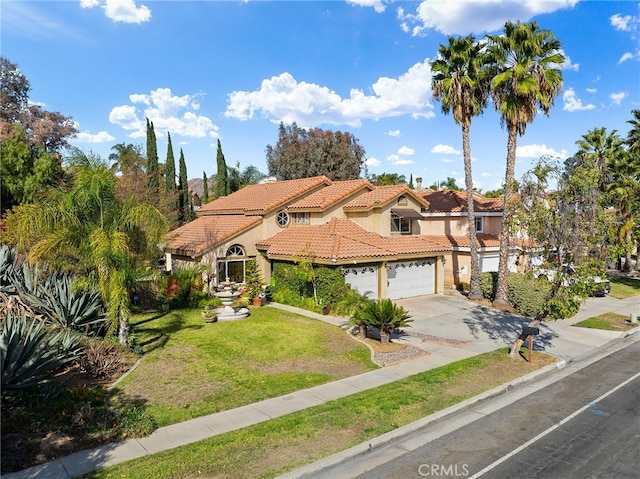 mediterranean / spanish-style home with a garage and a front lawn