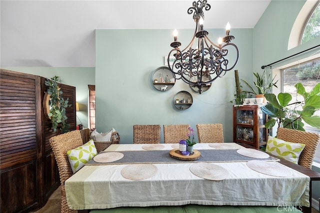 dining room featuring a chandelier and lofted ceiling