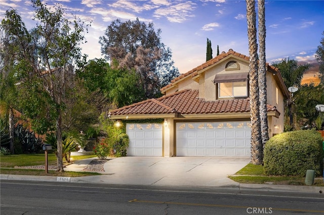 mediterranean / spanish-style home featuring a garage