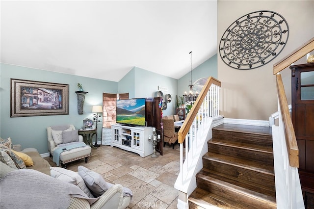 living room with a notable chandelier and vaulted ceiling