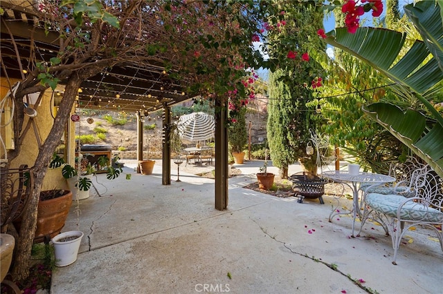 view of patio / terrace featuring an outdoor fire pit