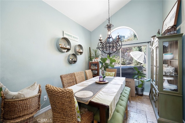 dining space with high vaulted ceiling and an inviting chandelier