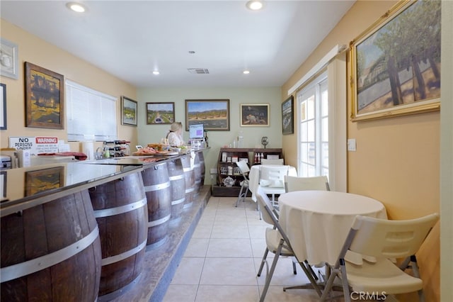 tiled dining space featuring recessed lighting and visible vents