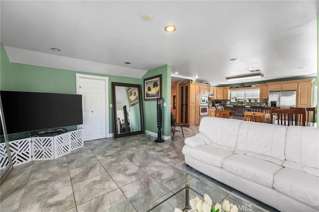 living room with recessed lighting and baseboards