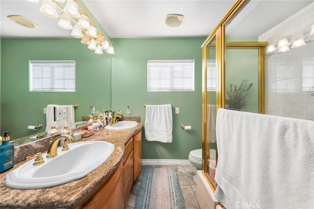 bathroom featuring plenty of natural light, a sink, and a shower stall