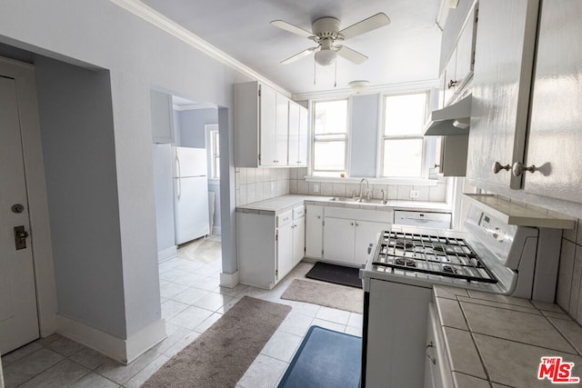 kitchen featuring tile counters, white appliances, white cabinetry, and sink