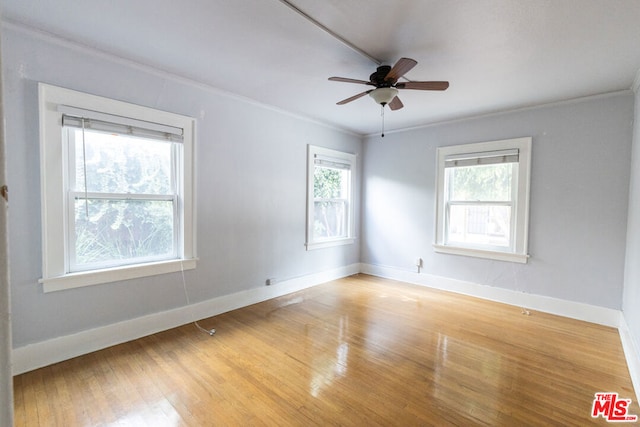 spare room featuring hardwood / wood-style flooring, ceiling fan, and ornamental molding