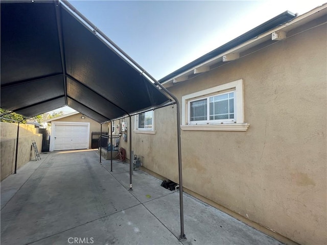 view of side of home featuring a garage and an outdoor structure