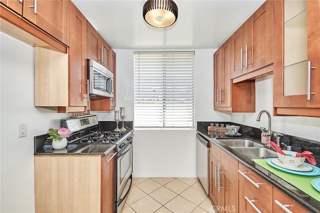 kitchen with light tile patterned floors, stainless steel appliances, and sink