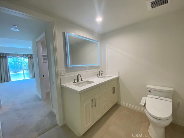 bathroom with vanity, tile patterned flooring, and toilet