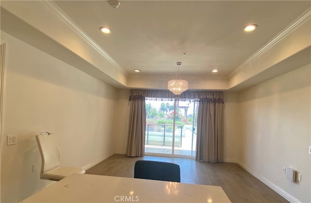 unfurnished dining area with wood-type flooring, crown molding, and an inviting chandelier